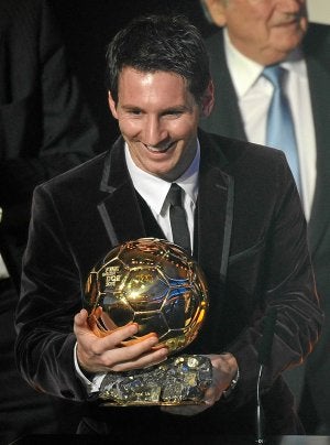 Messi, muy sonriente sostiene en las manos su tercer Balón de Oro. :: AFP/