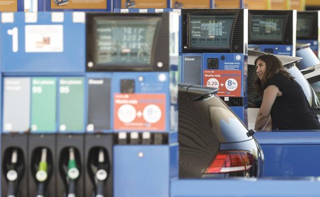 A driver fills up at a gas station. 